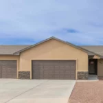 modern home with xeriscaping landscaping 3 car garage