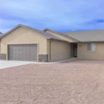 modern home with xeriscaping landscaping 3 car garage